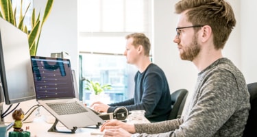 two people working at computer